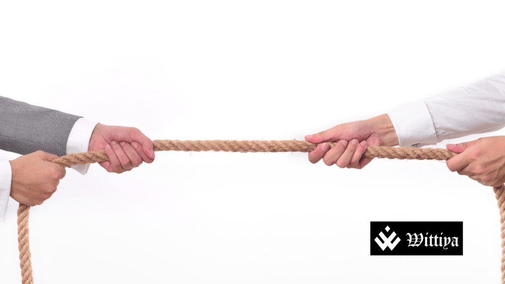 Two business professionals in a tug of war, symbolizing a hostile takeover struggle.