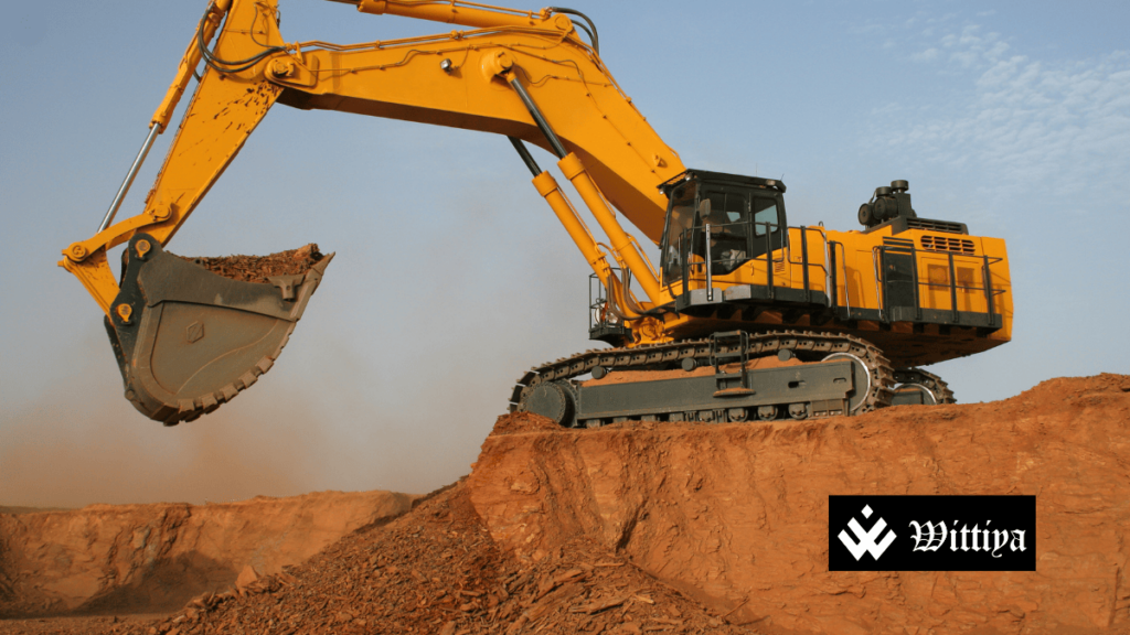 A JCB excavator at a mining site, representing NMDC’s operations and its ₹2.30 dividend announcement for FY25.